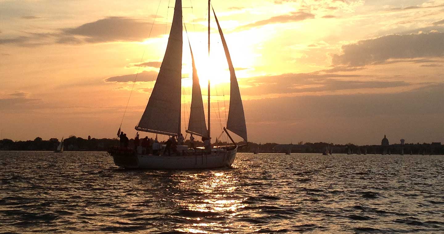 Schooner silhouette at sunset in the harbor when you visit Annapolis, Chesapeake Bay.
