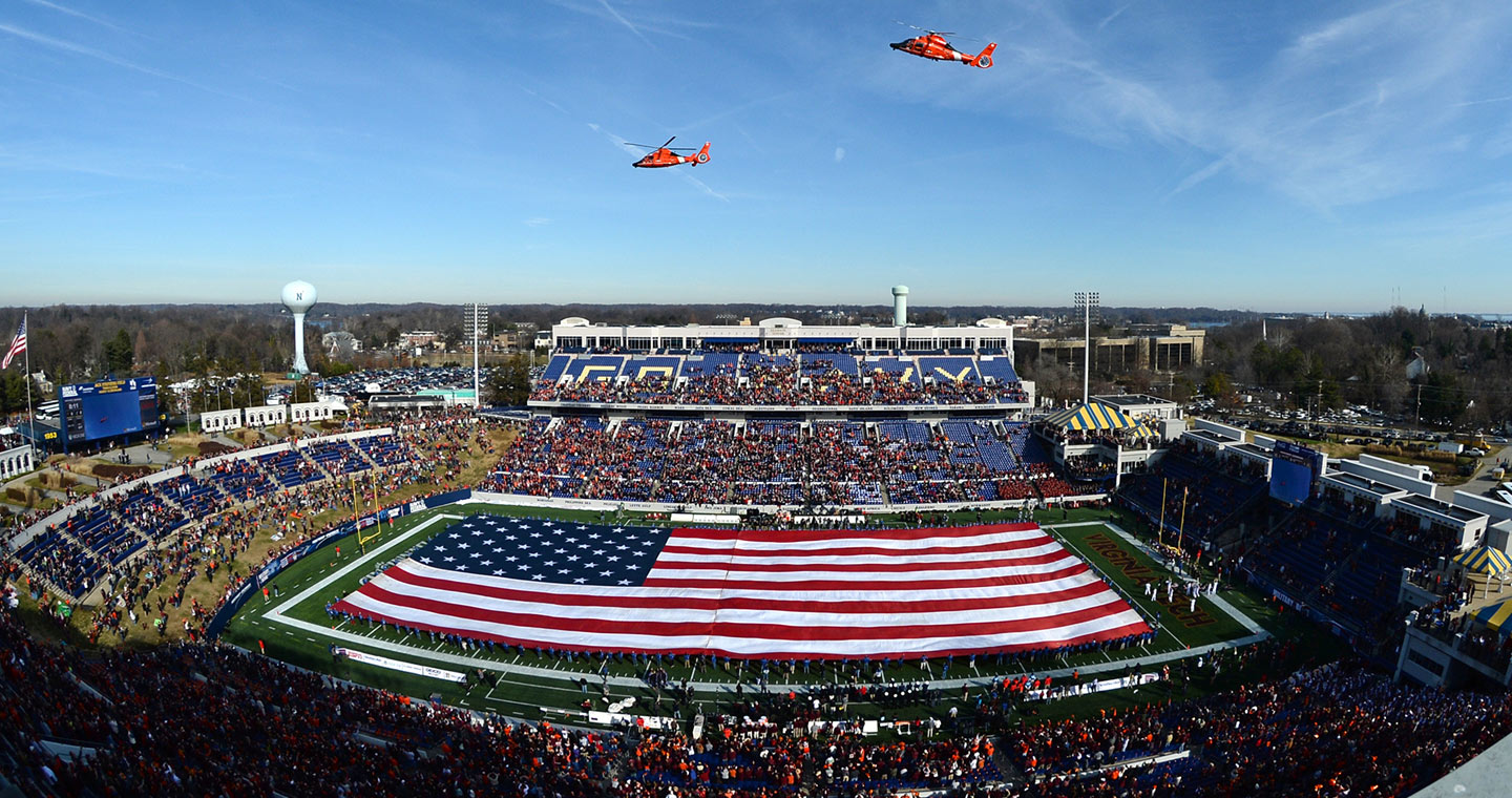 Coast Guard helicopters fly over Navy-Marine Corps Memorial Stadium